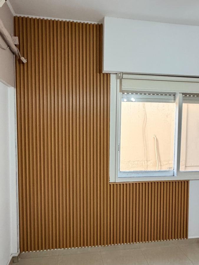 Pared de dormitorio con wallpanel símil madera